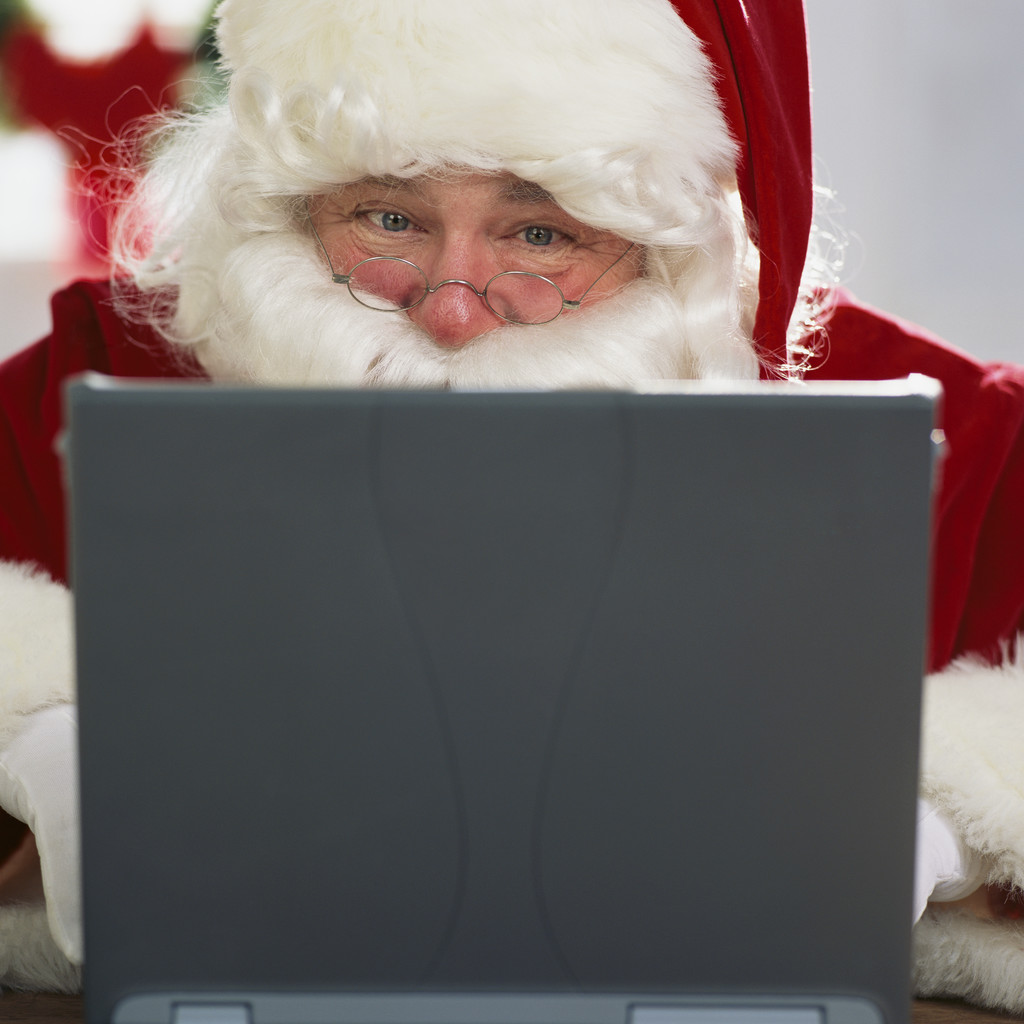 Santa Claus Using Laptop --- Image by © Royalty-Free/Corbis
